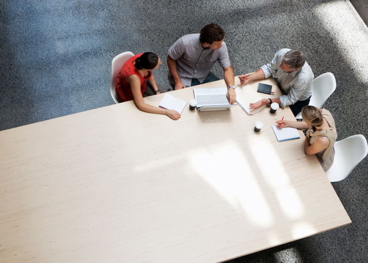 people working at big table